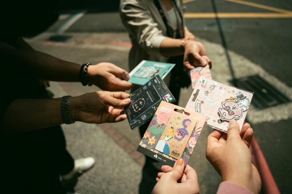 A group exchanging vibrant stationery cards outdoors for a street marketing.